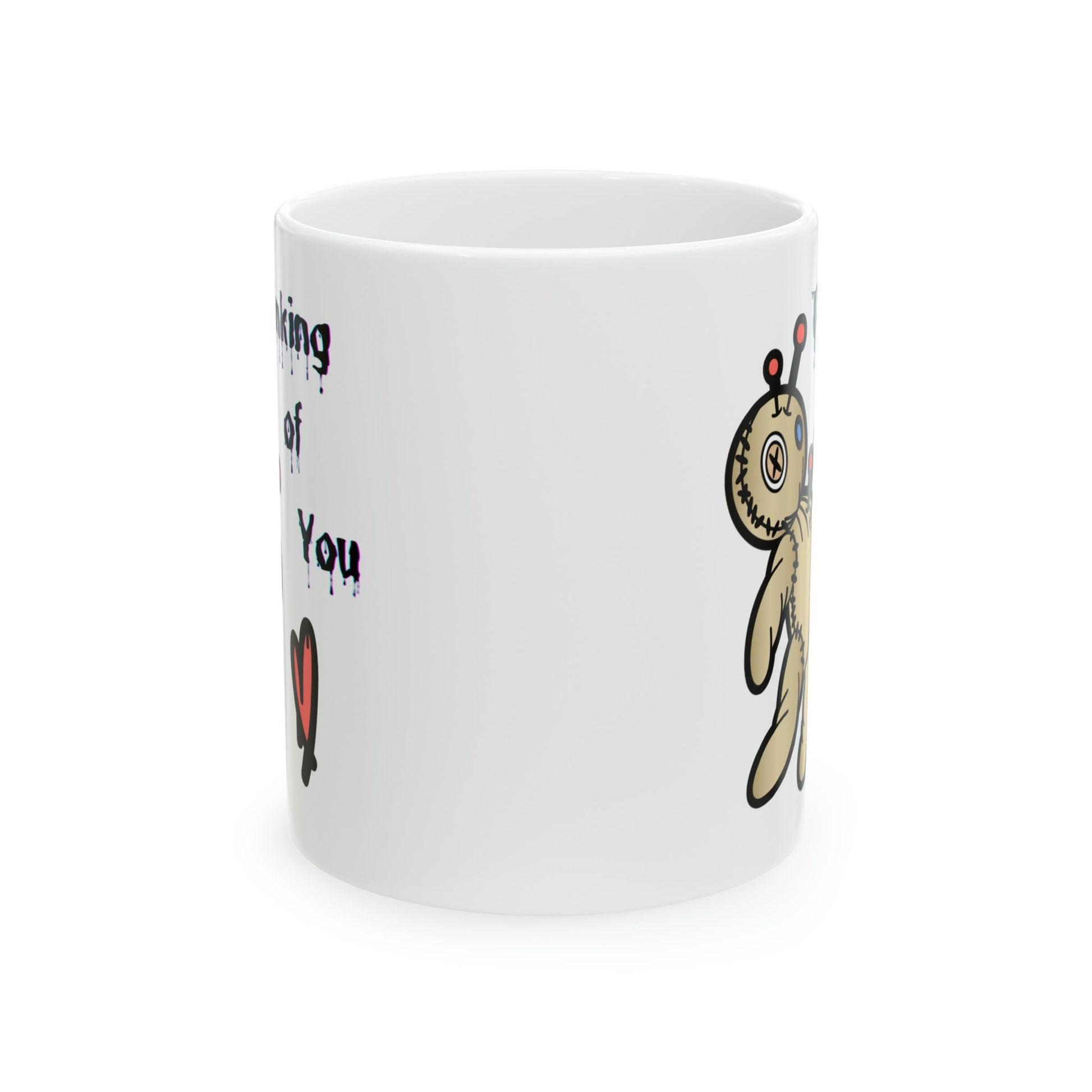 white ceramic coffee mug with a Voo doo doll being poked with pins.  The words Thinking of you are written in a scary dripping Halloween Font.  A red heart is under the wording.  Check out my shop at www.scorpiontees.etsy.com