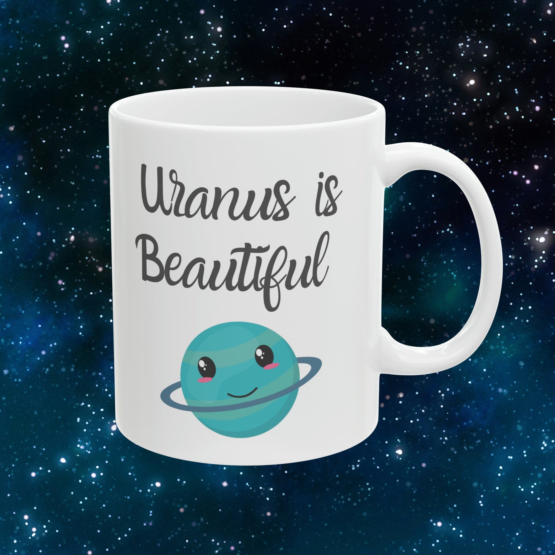 White Ceramic Mug with words in Script style black font that say, Uranus is Beautiful.  Beneath you find a Cute graphic of the Planet Uranus with an adorable face.  Check out the shop for more items at www.scorpiontees.etsy.com