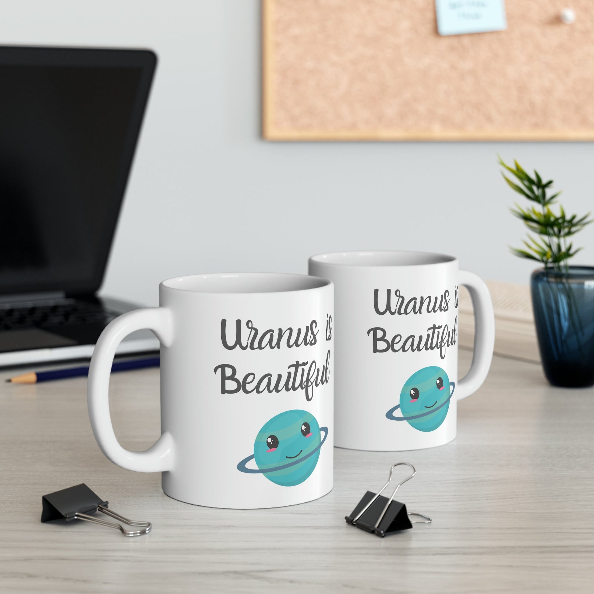 White Ceramic Mug with words in Script style black font that say, Uranus is Beautiful.  Beneath you find a Cute graphic of the Planet Uranus with an adorable face.  Check out the shop for more items at www.scorpiontees.etsy.com