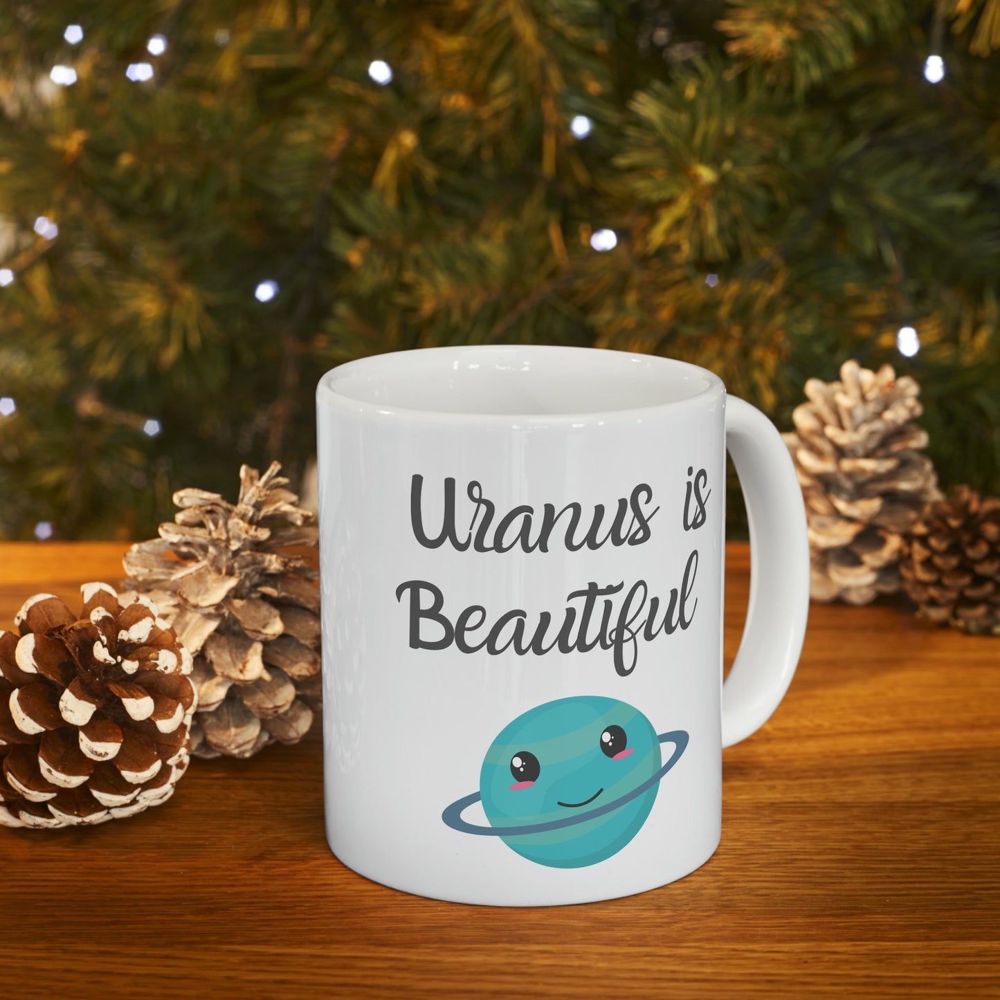 White Ceramic Mug with words in Script style black font that say, Uranus is Beautiful.  Beneath you find a Cute graphic of the Planet Uranus with an adorable face.  Check out the shop for more items at www.scorpiontees.etsy.com