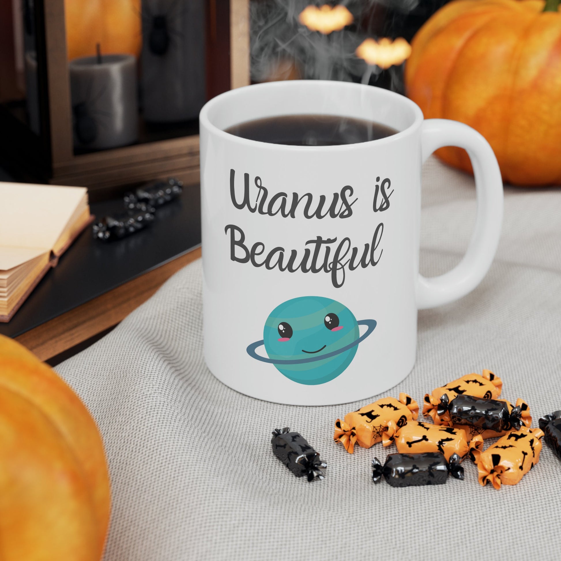 White Ceramic Mug with words in Script style black font that say, Uranus is Beautiful.  Beneath you find a Cute graphic of the Planet Uranus with an adorable face.  Check out the shop for more items at www.scorpiontees.etsy.com