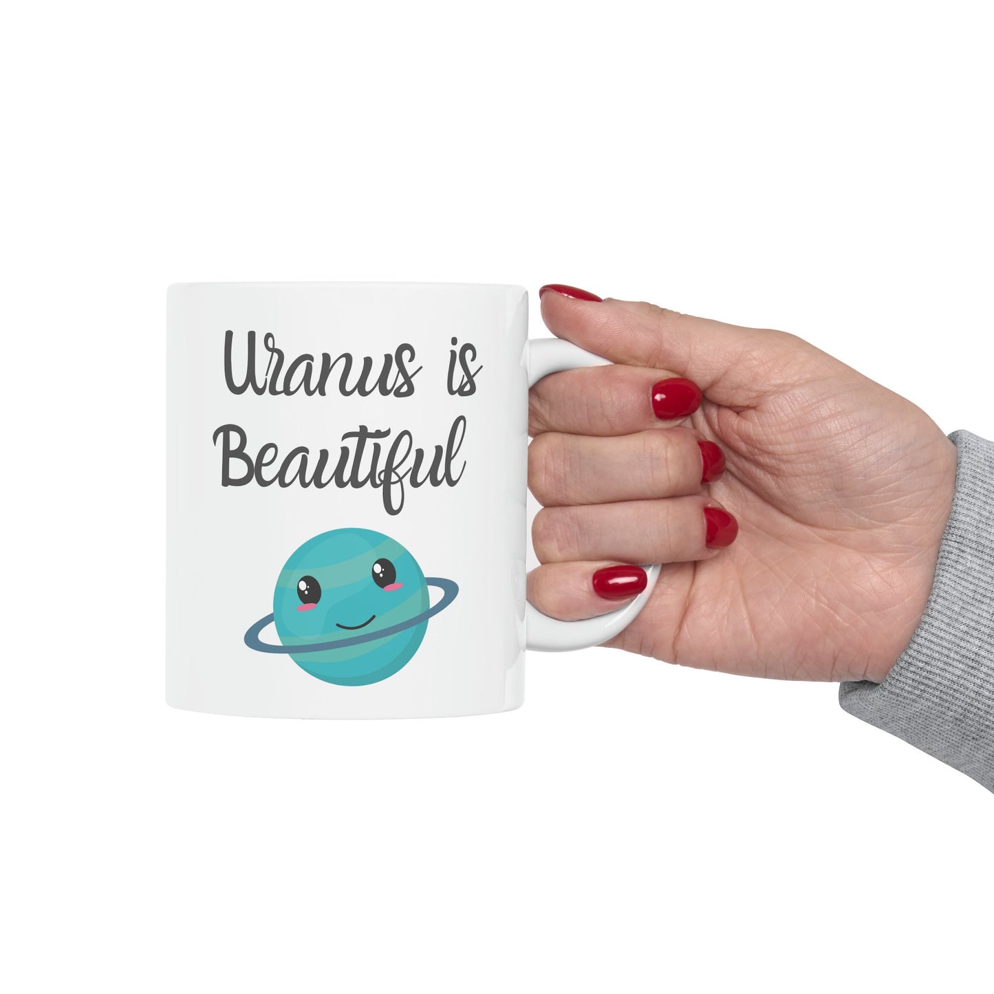 White Ceramic Mug with words in Script style black font that say, Uranus is Beautiful.  Beneath you find a Cute graphic of the Planet Uranus with an adorable face.  Check out the shop for more items at www.scorpiontees.etsy.com