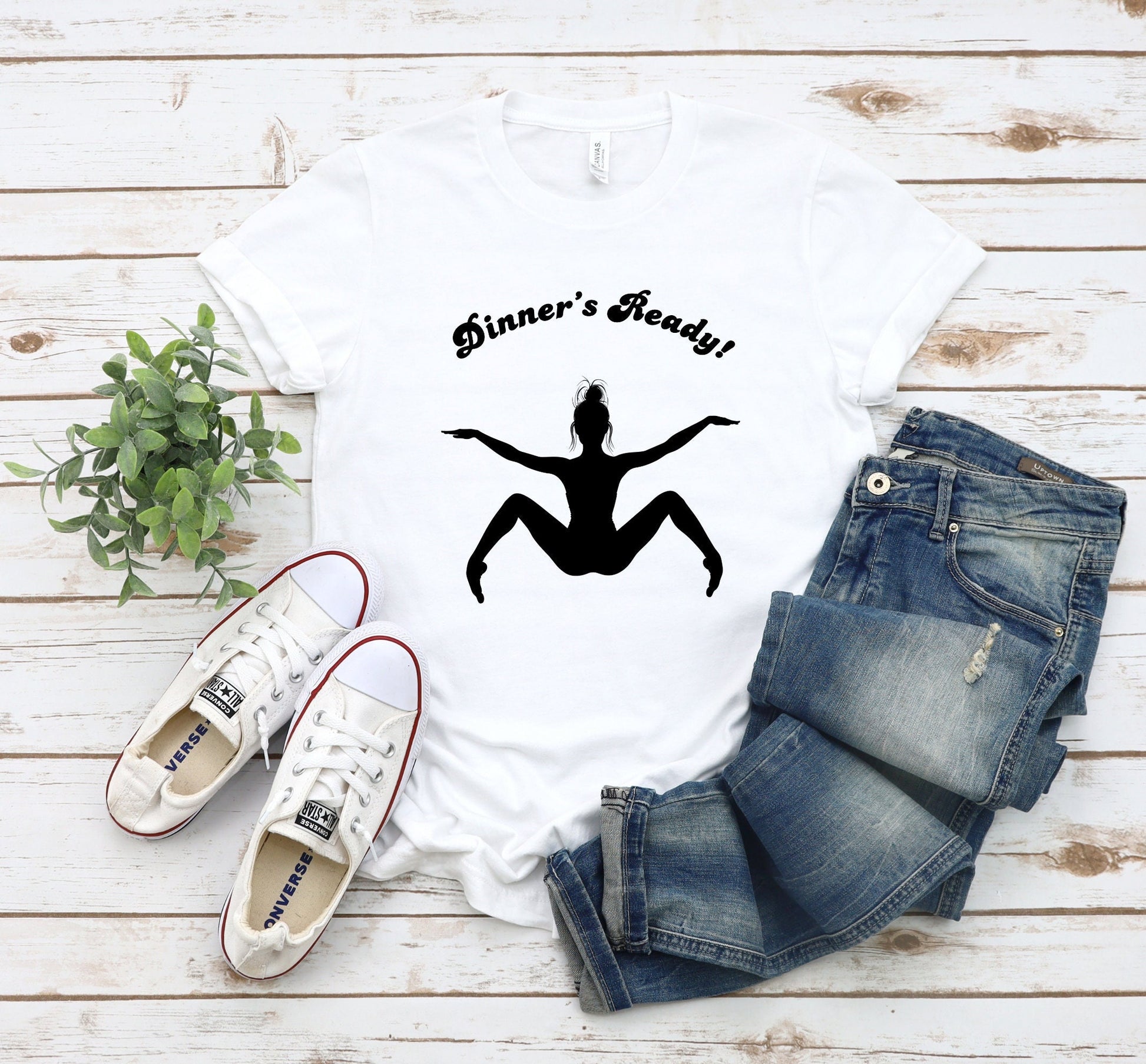 A Funny TShirt featuring the Silhouette of a woman with her arms out and legs open.  Words above the image read Dinners Ready.
www.scorpiontees.etsy.com