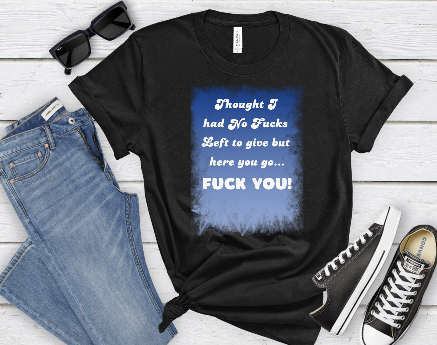 Awesome shirt. Design has blue backdrop with a grunge border.  The words on the design say Thought I had no fucks to give but here you go.  Fuck You! font color is white.
www.scorpiontees.etsy.com