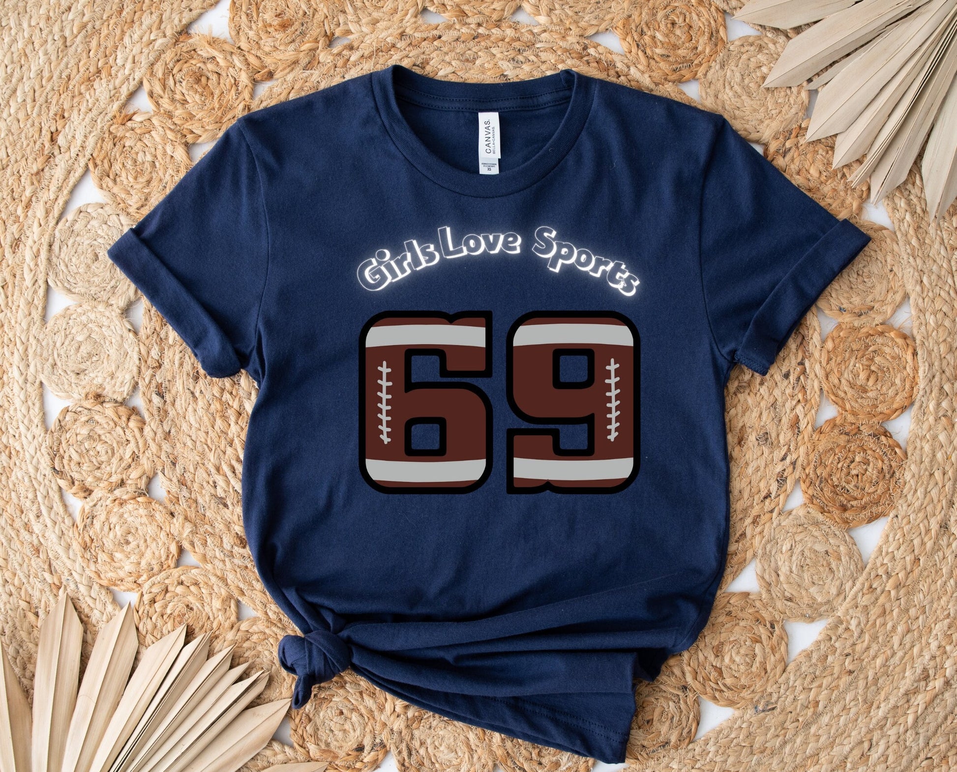 Awesome Graphic Tee Shirt for Women who love sports and have Bad Girl sense of Humor. The Shirt has the number 69 which has the patter of a Football and says Girls Love Sports above in a curved fashion.
www.scorpiontees.etsy.com