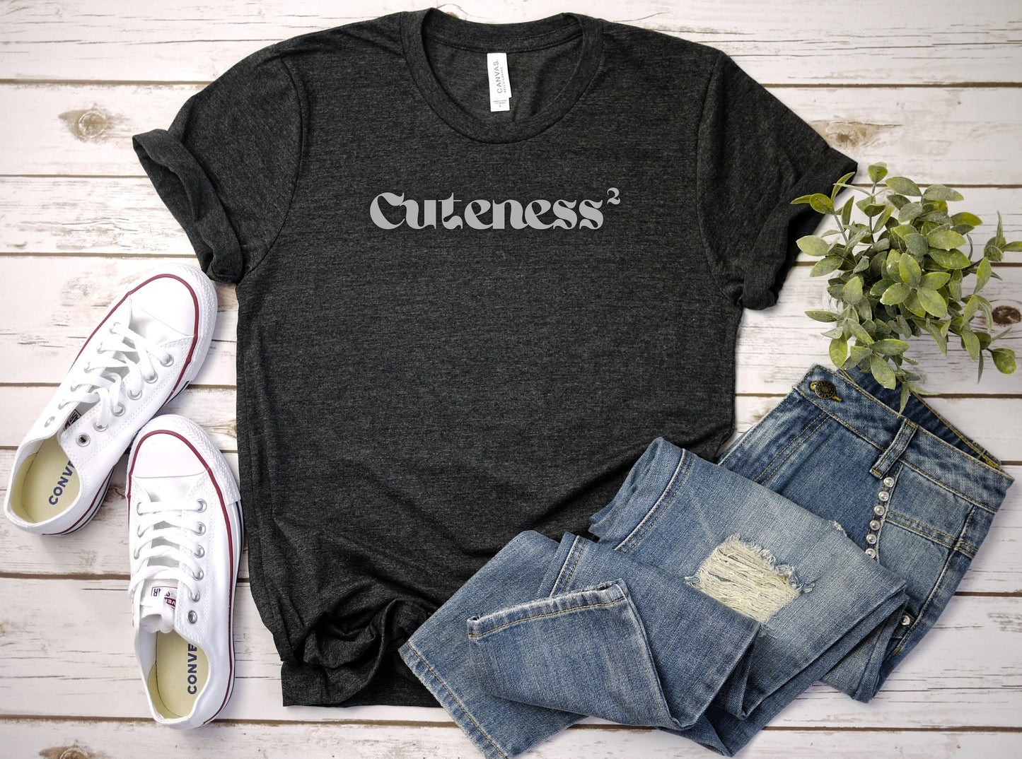 Very Simple and perfect Design with word Cuteness followed by the exponent number two.  Cuteness Squared is the positive message displayed.  The Font is a Dark Gray for light colors and Light Gray for dark Colors.  www.scorpiontees.etsy.com