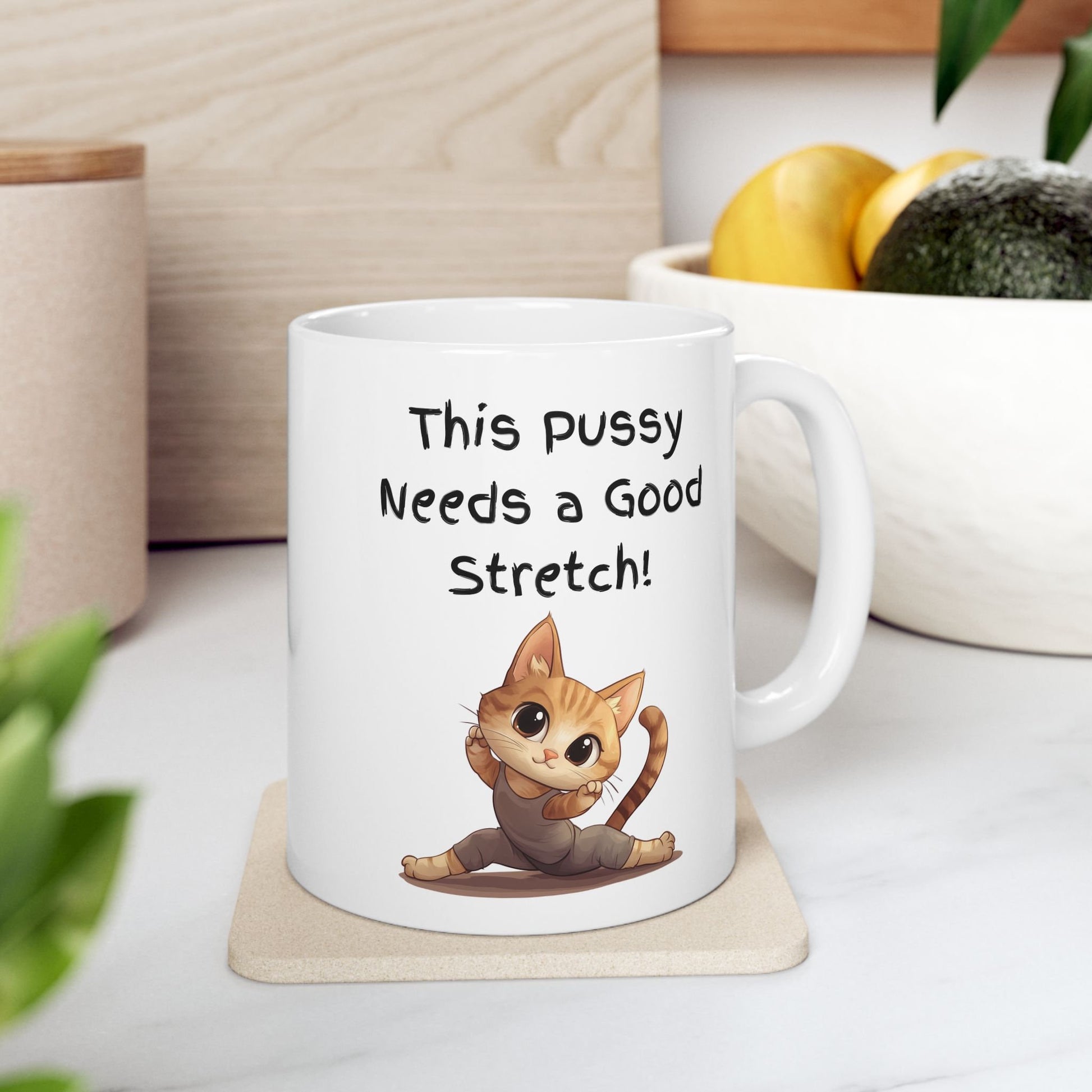 White Ceramic 11oz coffee mug with the Words This pussy needs a good stretch in finger paint font. Below the words there is a Cartoon cat stretching doing a split. Hilarious sexy mug for you coffee tea or favorite drink 
www.scorpiontees.etsy.com