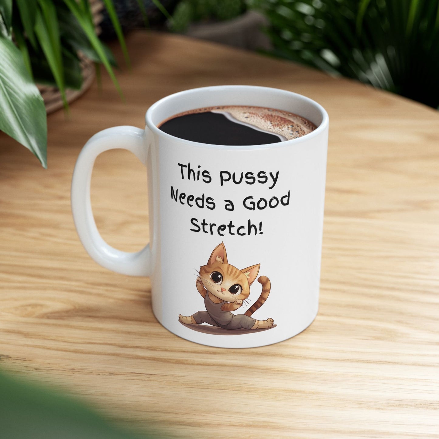 White Ceramic 11oz coffee mug with the Words This pussy needs a good stretch in finger paint font. Below the words there is a Cartoon cat stretching doing a split. Hilarious sexy mug for you coffee tea or favorite drink 
www.scorpiontees.etsy.com