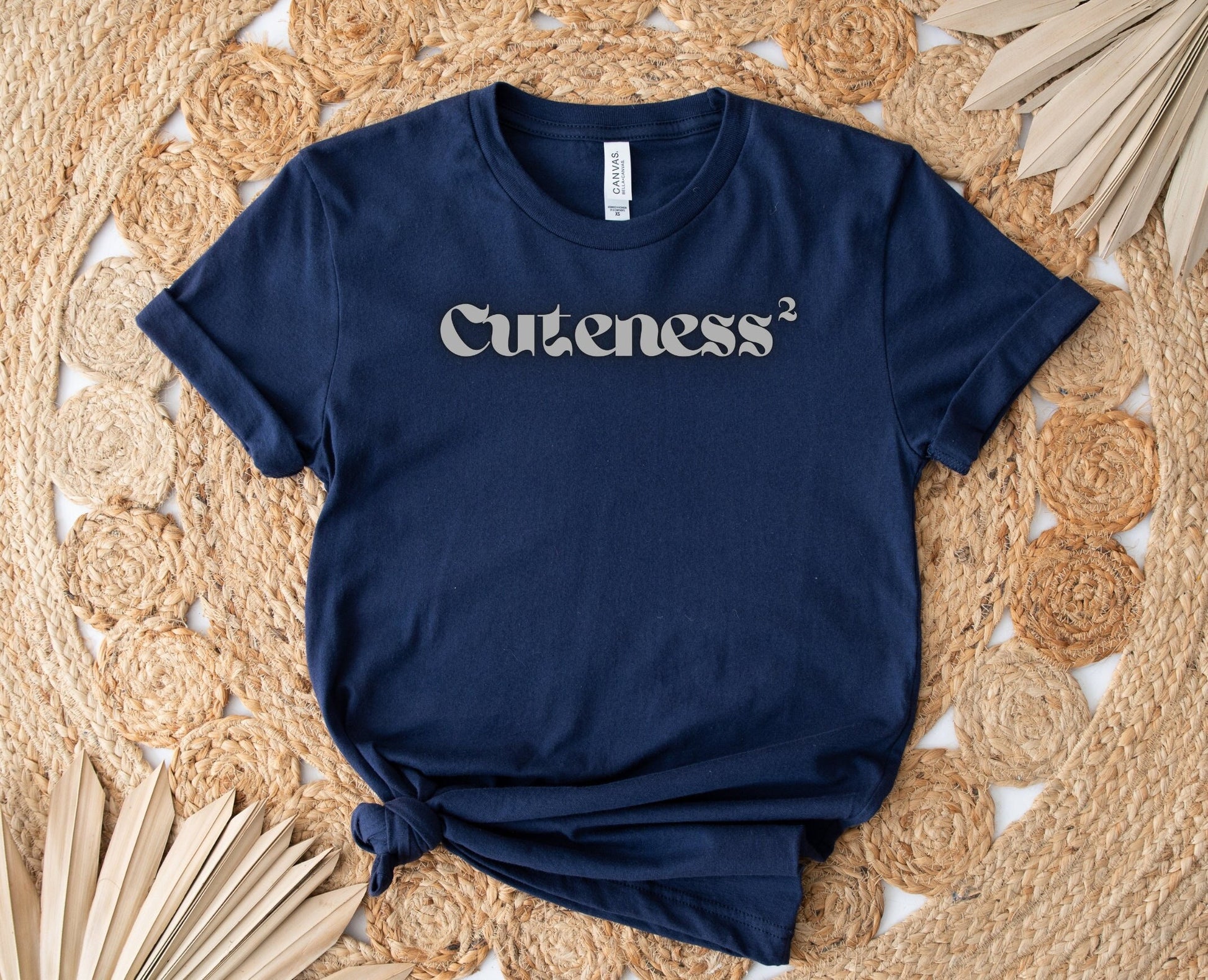 Very Simple and perfect Design with word Cuteness followed by the exponent number two.  Cuteness Squared is the positive message displayed.  The Font is a Dark Gray for light colors and Light Gray for dark Colors.  www.scorpiontees.etsy.com