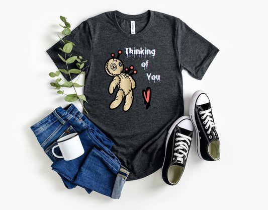 Thinking of you Voodoo doll T shirt. Scorned lover or sarcastic thoughts as voodoo doll is being stuck with pins in his heart. Hilariously cute design on a comfortable T shirt.  Perfect gift for Halloween or just for fun.
www.scorpiontees.etsy.com